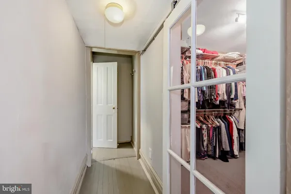 a view of a hallway with wooden floor and entryway