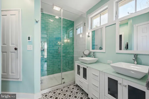 a kitchen with a refrigerator and a stove top oven