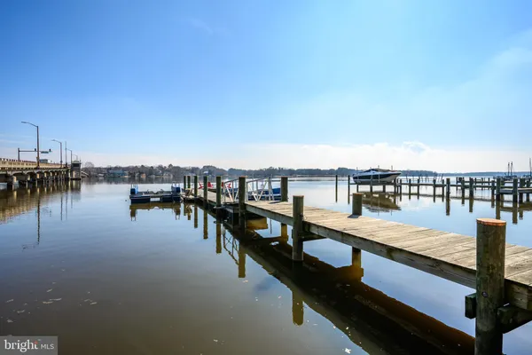 a front view of a building with trees and covered with snow