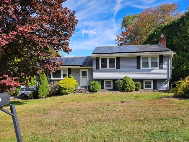 a front view of a house with a yard