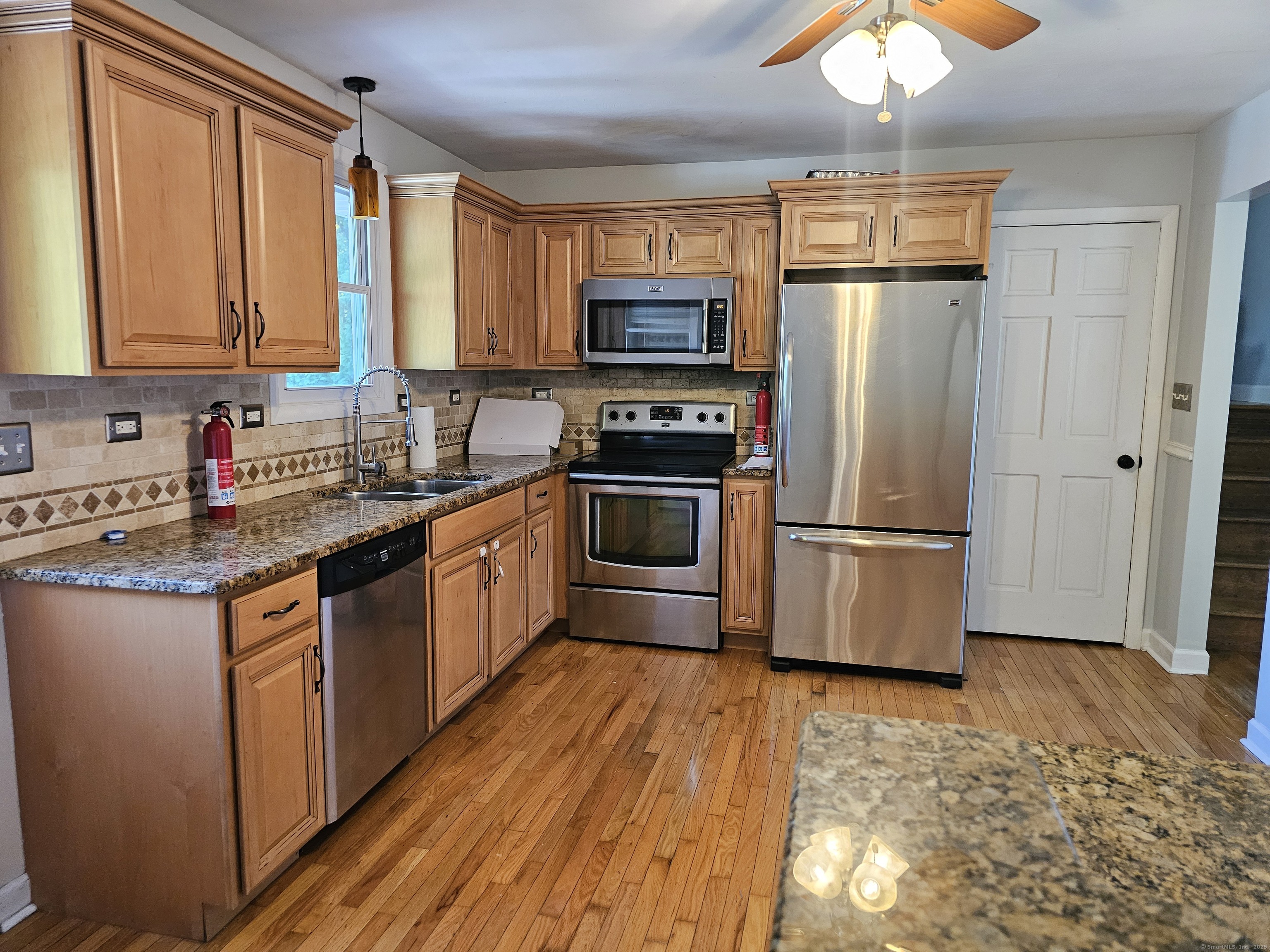 222 Crest Street Waterbury, CT 06708 - Photo 3 of 15 a kitchen with stainless steel appliances granite countertop a refrigerator a stove a sink and a microwave