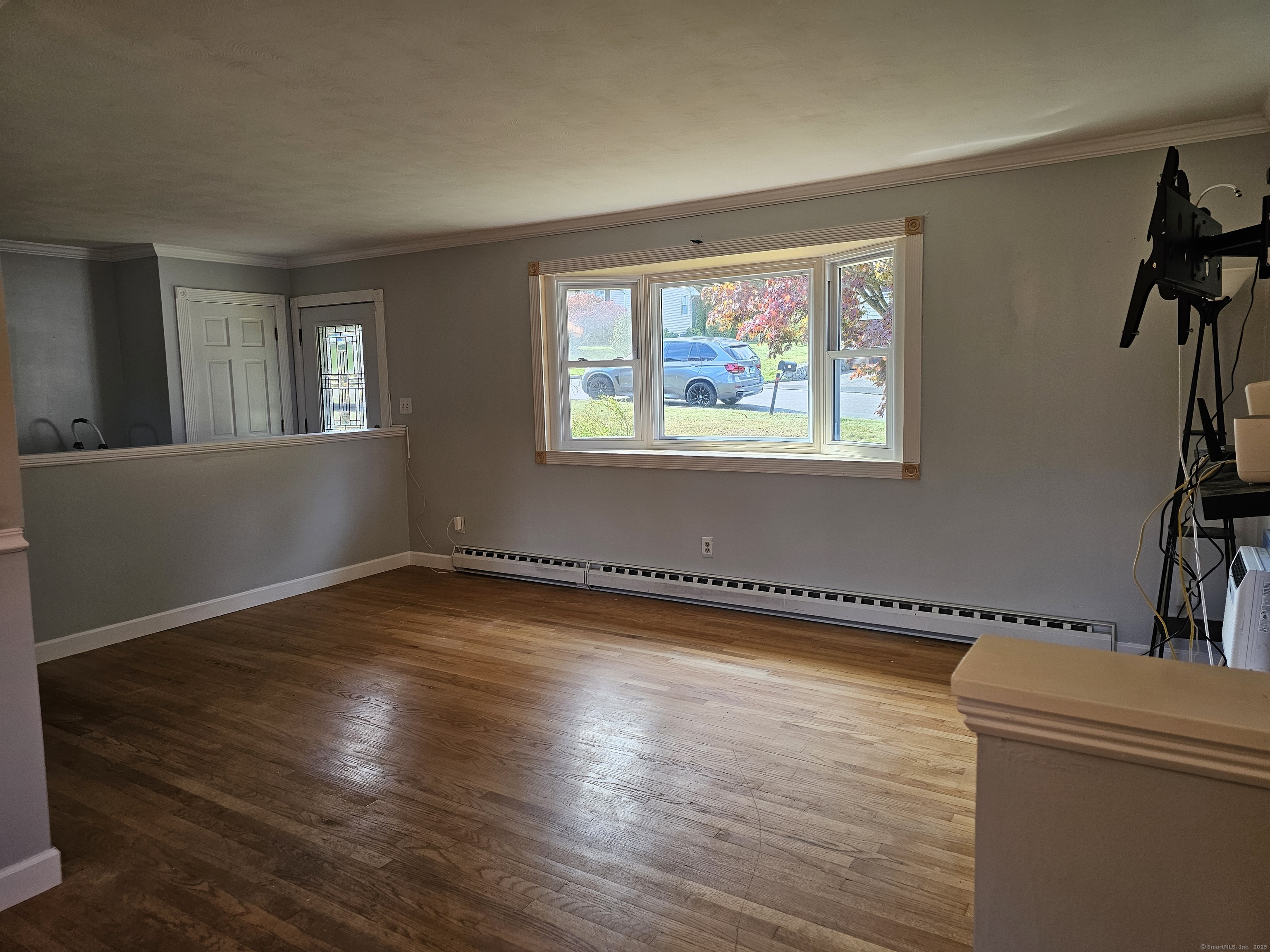 222 Crest Street Waterbury, CT 06708 - Photo 6 of 15 a view of a room with wooden floor and fan