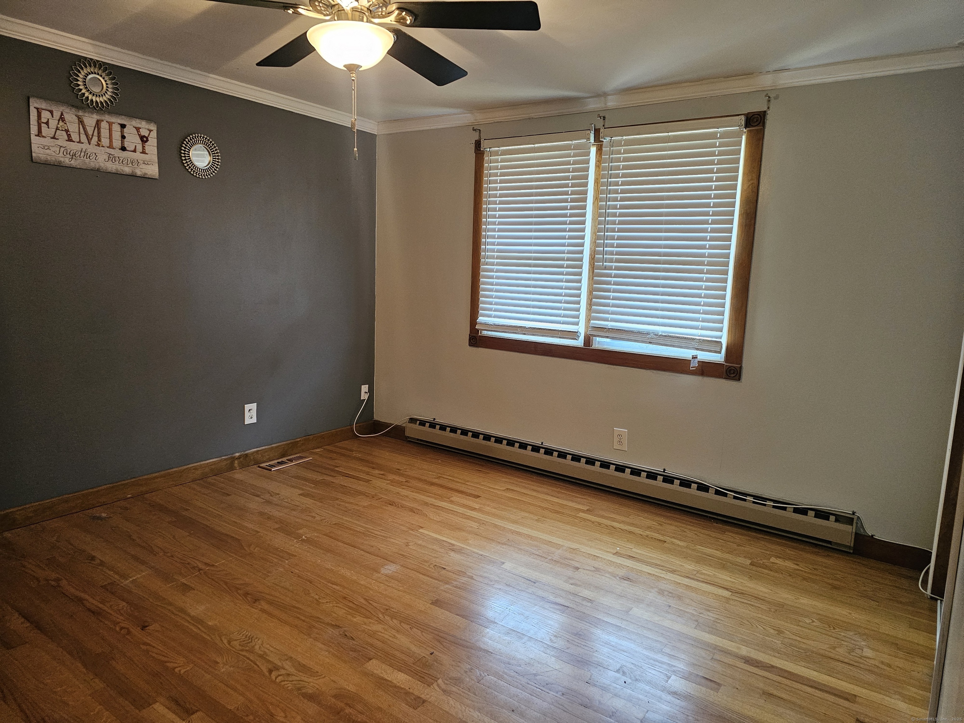 222 Crest Street Waterbury, CT 06708 - Photo 10 of 15 an empty room with wooden floor and windows