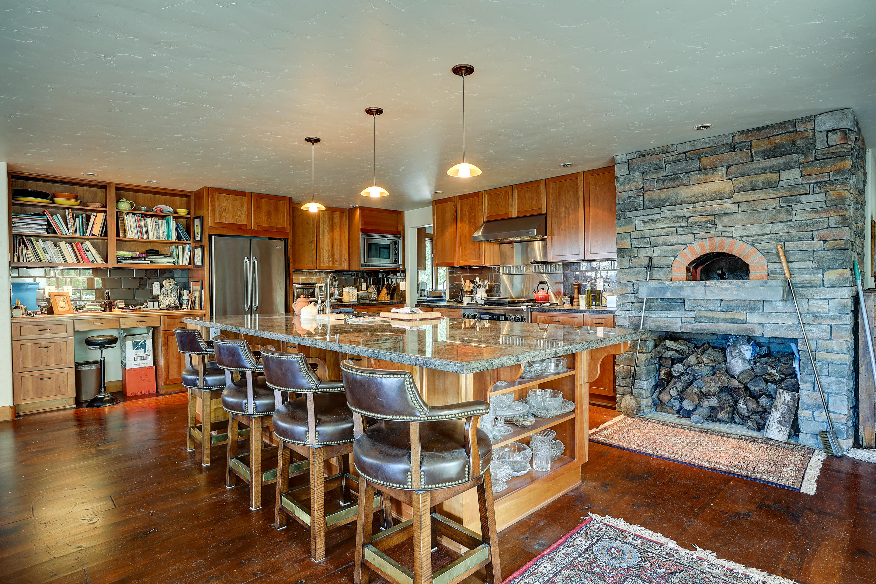 60430 Woodside Road Bend, OR 97702 - Photo 13 of 18 a open kitchen with stainless steel appliances granite countertop a stove and a wooden floors