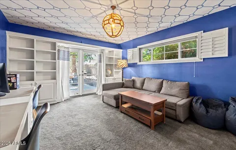 a living room with furniture and a clock