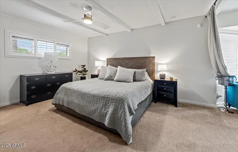 a bedroom with a bed and a dresser