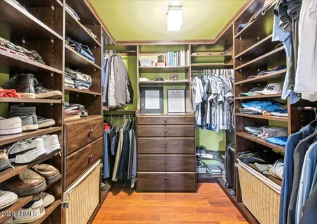 a bedroom with a bed chair and a large window