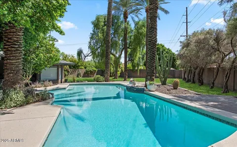 a swimming pool with outdoor seating and yard