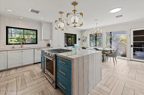 a kitchen with stainless steel appliances granite countertop a stove and a sink