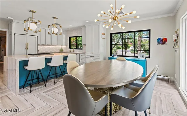 a dining room with furniture a chandelier and wooden floor