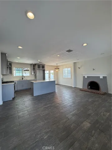 a view of kitchen and hall with wooden floor