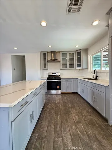 a large kitchen with kitchen island a sink stainless steel appliances and cabinets