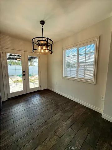 a view of a room with wooden floor cabinet and windows