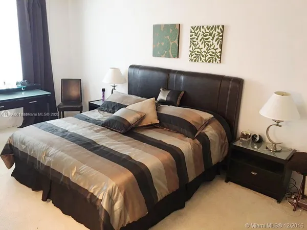 a bedroom with a bed and a night stand