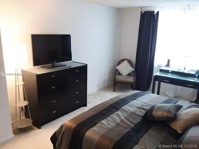 a bedroom with a bed and television