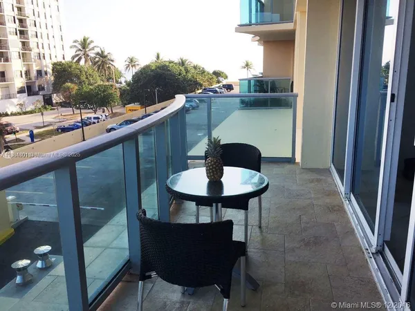 a balcony view with a sink and chair