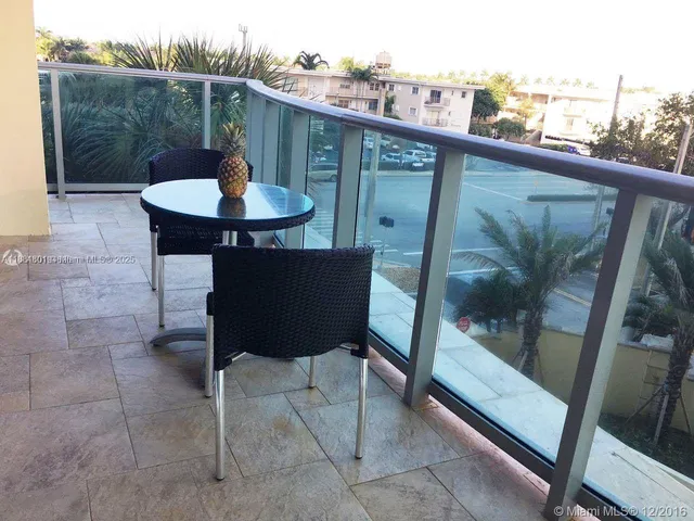 a balcony with table and chairs