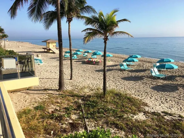 a living room with furniture and a gym machine