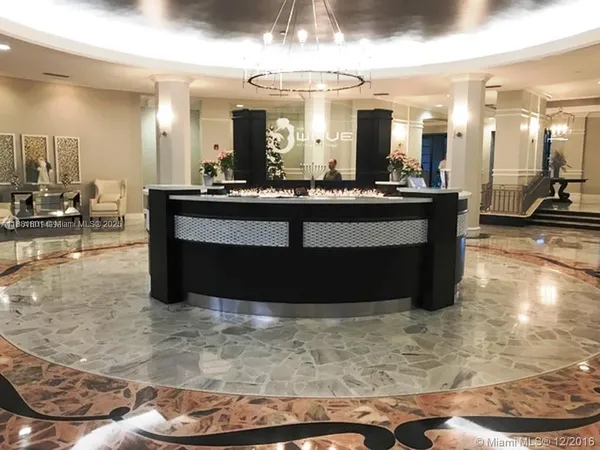 a view of living room with kitchen island granite countertop furniture and a large window