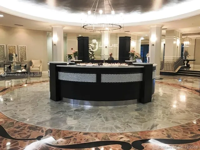 a view of living room with kitchen island granite countertop furniture and a large window