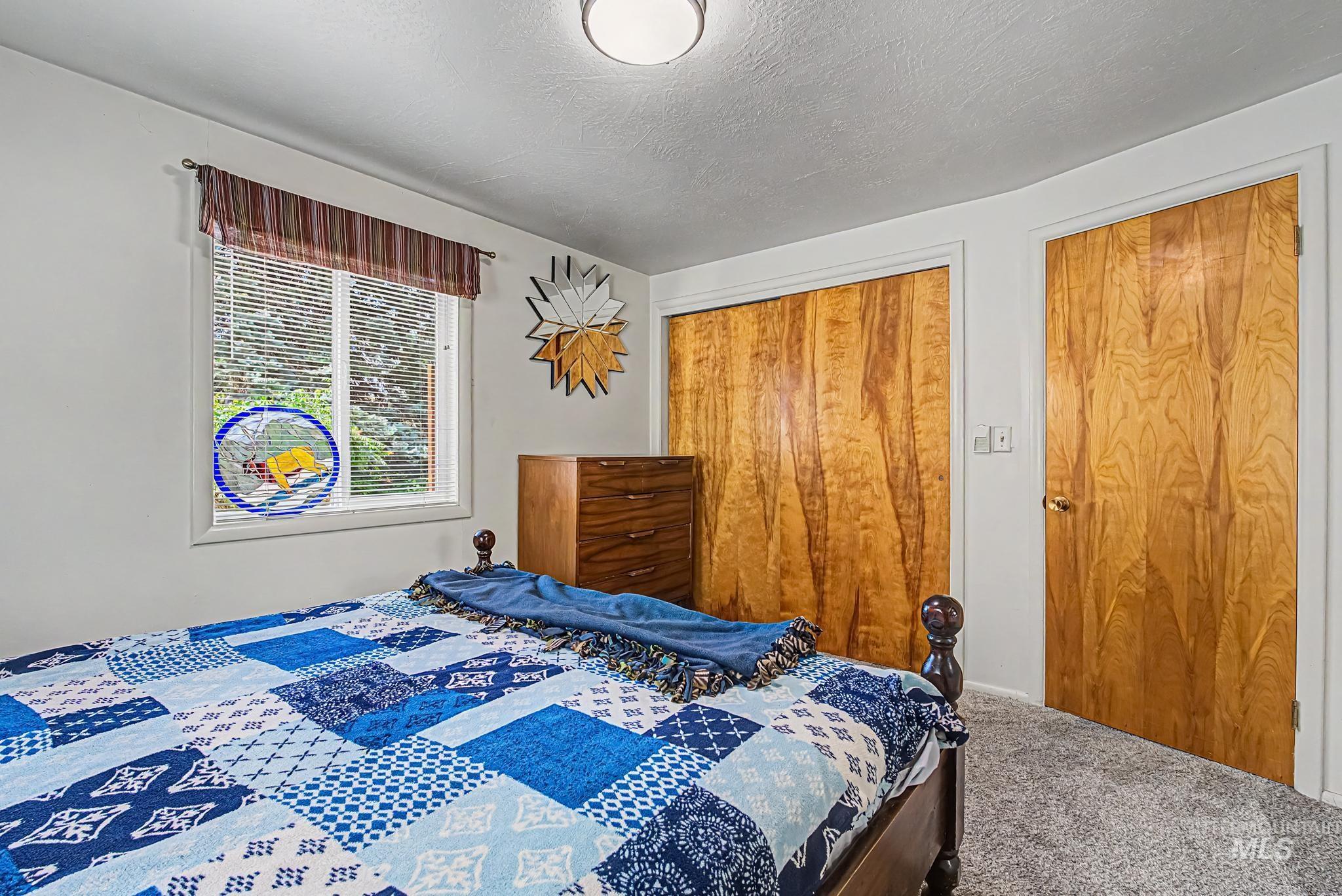 4311 Frozen Dog Road Emmett, ID 83617 - Photo 22 of 31 Bedroom featuring light gray walls and plush gray carpet flooring