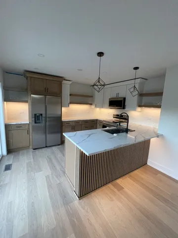 a view of a room with wooden floor