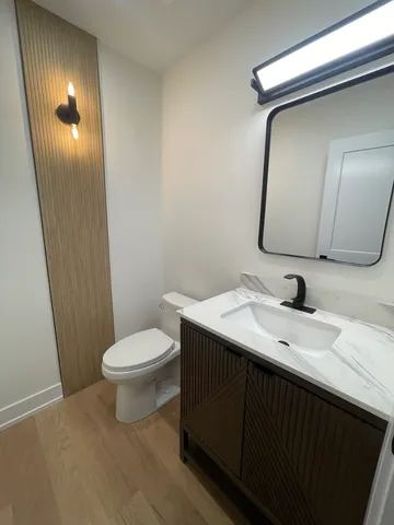 a bathroom with a toilet sink and mirror