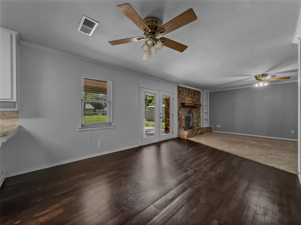 220 Cooper Drive Hurst, TX 76053 - Photo 12 of 27 a view of an empty room with wooden floor and a window