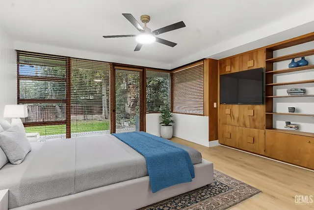 a bed sitting in a bedroom next to a window