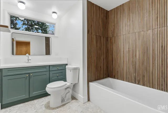 a bathroom with a toilet a sink and bathtub