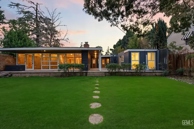 a front view of house with yard and green space