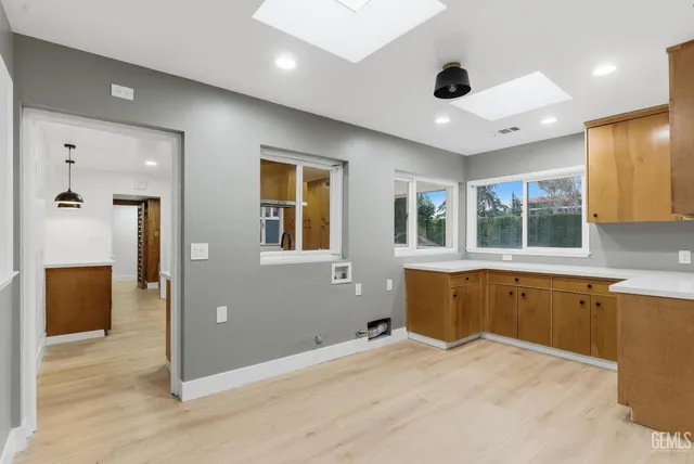 a large white room with a large window and chandelier
