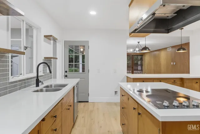 a kitchen that has a sink and a stove