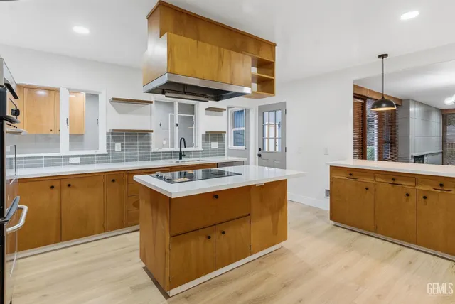 a kitchen with stainless steel appliances granite countertop a stove and a sink