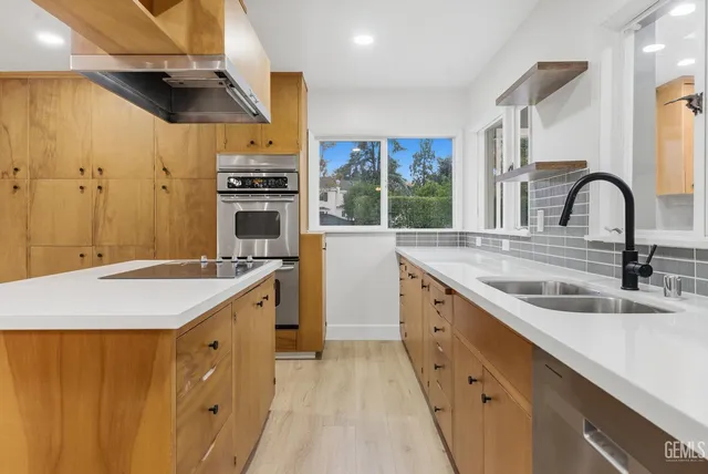 a kitchen with a sink stove and cabinets
