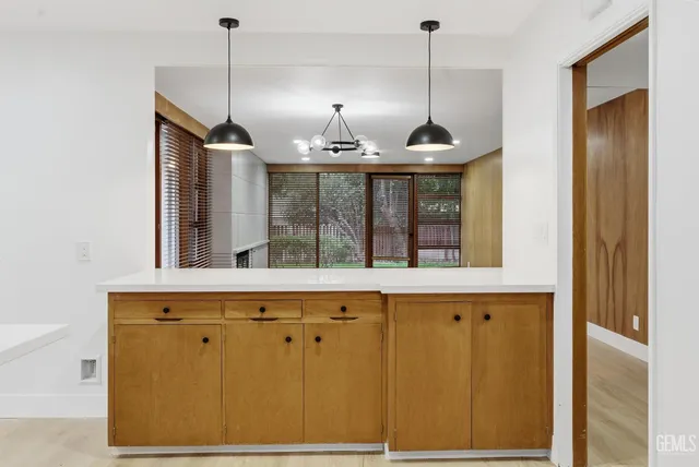 a kitchen with a sink a refrigerator and window