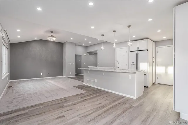 a view of kitchen with refrigerator and window