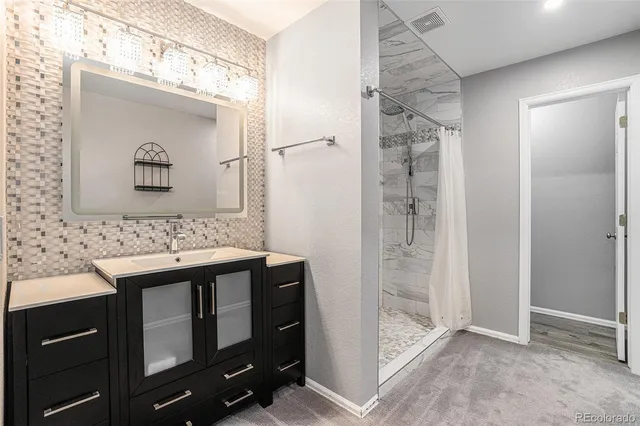 a bathroom with a glass door shower