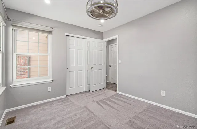 a bathroom with a granite countertop bathtub shower sink vanity mirror and toilet