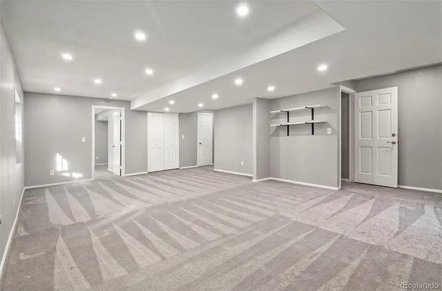 an empty room with wooden floor and window