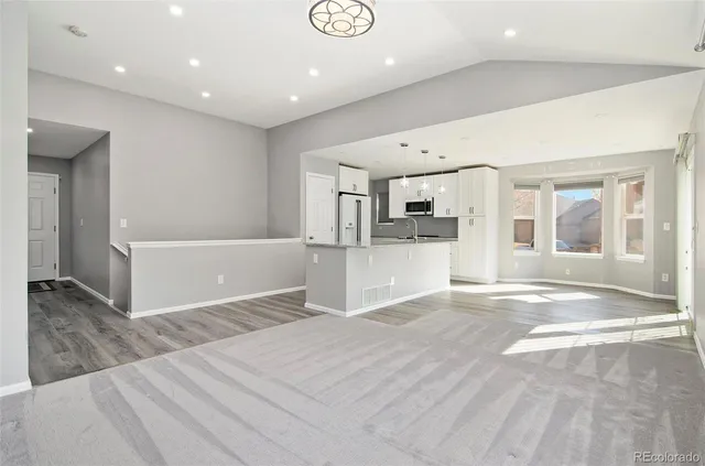 a view of a kitchen with a sink and cabinets