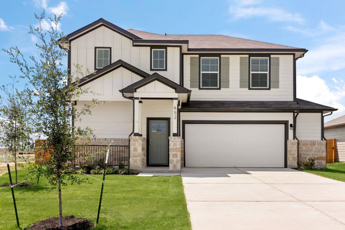 452 Town Lk Bend Kyle, TX 78640 - Photo 1 of 1 a front view of a house with a yard and garage