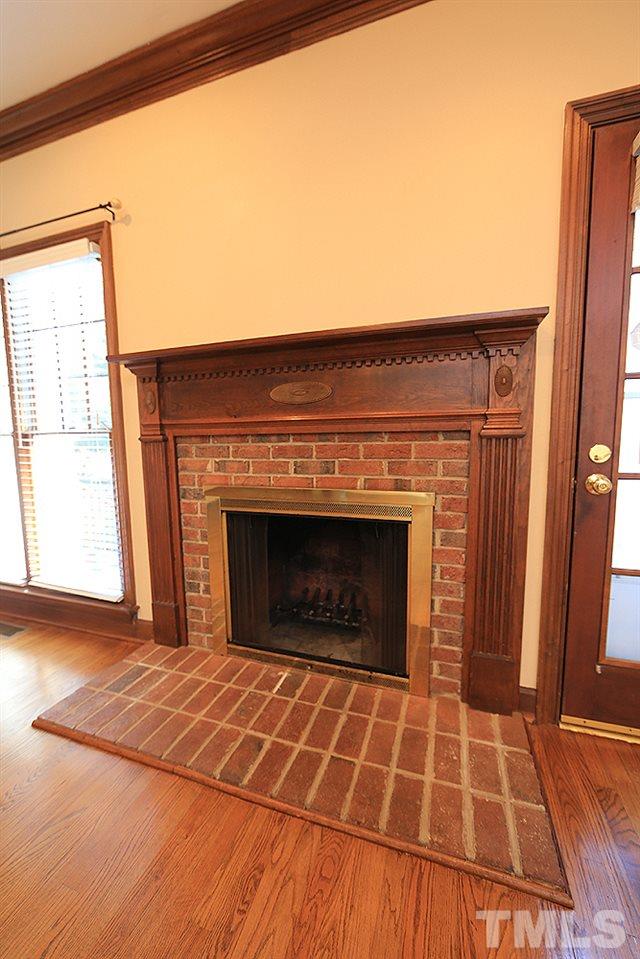 122 Skylark Way Raleigh, NC 27615 - Photo 13 of 30 a living room with a fireplace and a rug