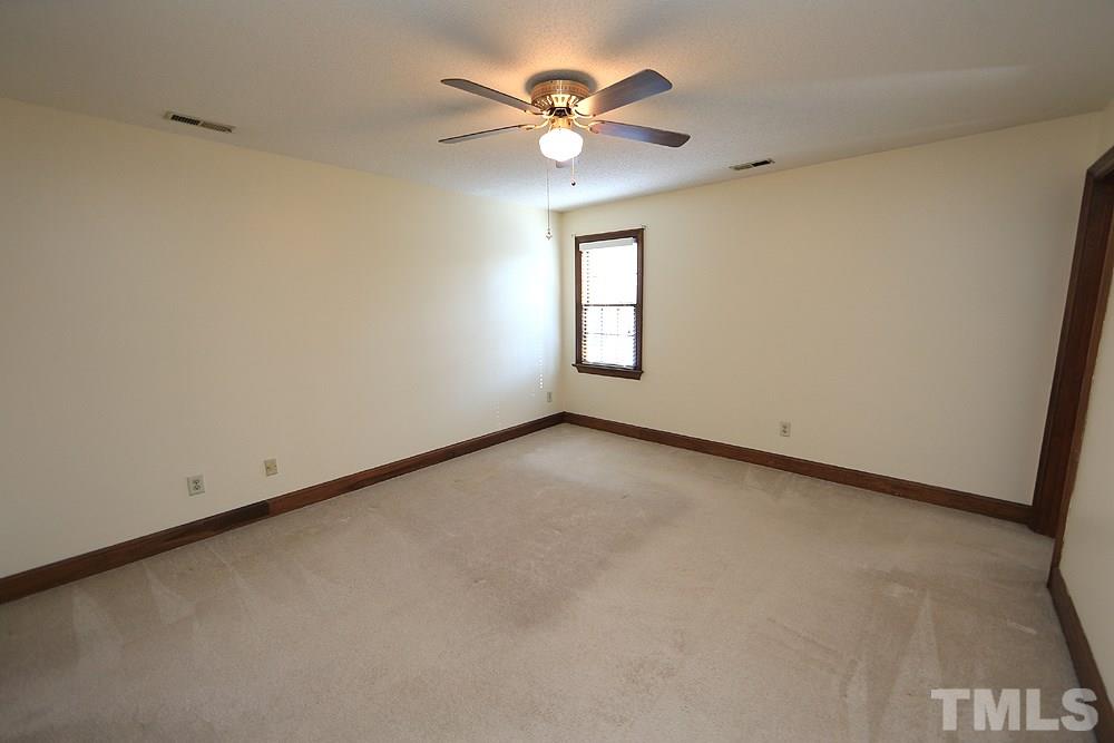 122 Skylark Way Raleigh, NC 27615 - Photo 17 of 30 an empty room with windows and fan