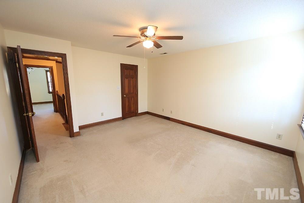 122 Skylark Way Raleigh, NC 27615 - Photo 18 of 30 an empty room with a ceiling fan and a window