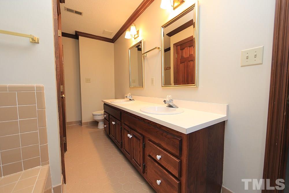 122 Skylark Way Raleigh, NC 27615 - Photo 20 of 30 a bathroom with a sink and a mirror