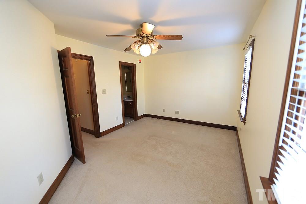 122 Skylark Way Raleigh, NC 27615 - Photo 24 of 30 an empty room with a window and a ceiling fan