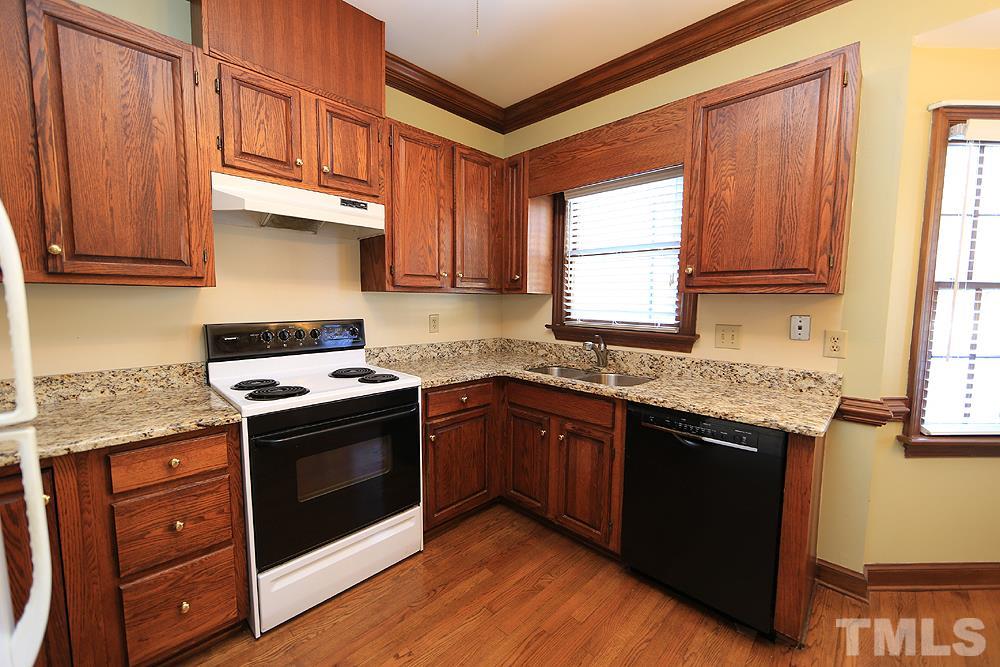 122 Skylark Way Raleigh, NC 27615 - Photo 8 of 30 a kitchen with stainless steel appliances granite countertop a stove a sink and a microwave