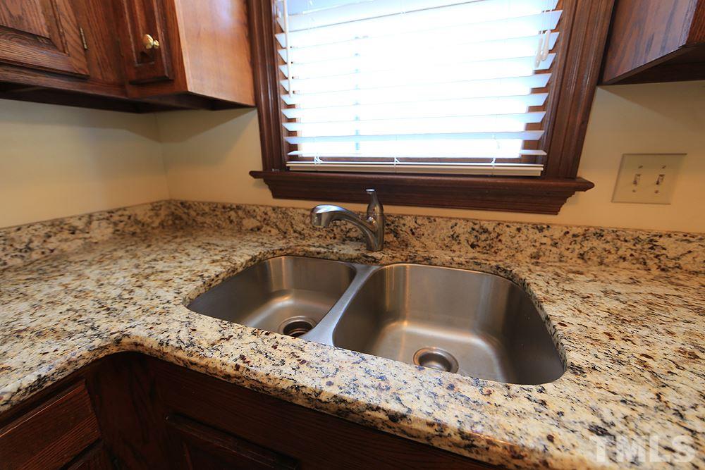 122 Skylark Way Raleigh, NC 27615 - Photo 9 of 30 a kitchen with a sink and a window