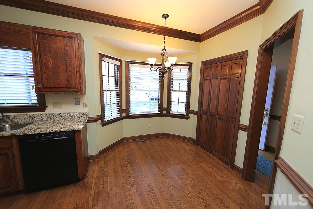 122 Skylark Way Raleigh, NC 27615 - Photo 10 of 30 a view of an empty room with a window and wooden floor
